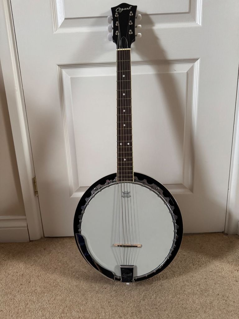 Ozark 6 string banjo guitar with hard case.