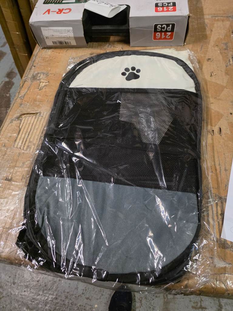 A new still packed pop up / folding Multi-Pet Portable Playpen .