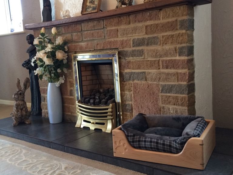 Wooden dog bed with removable grey and plaid cushion