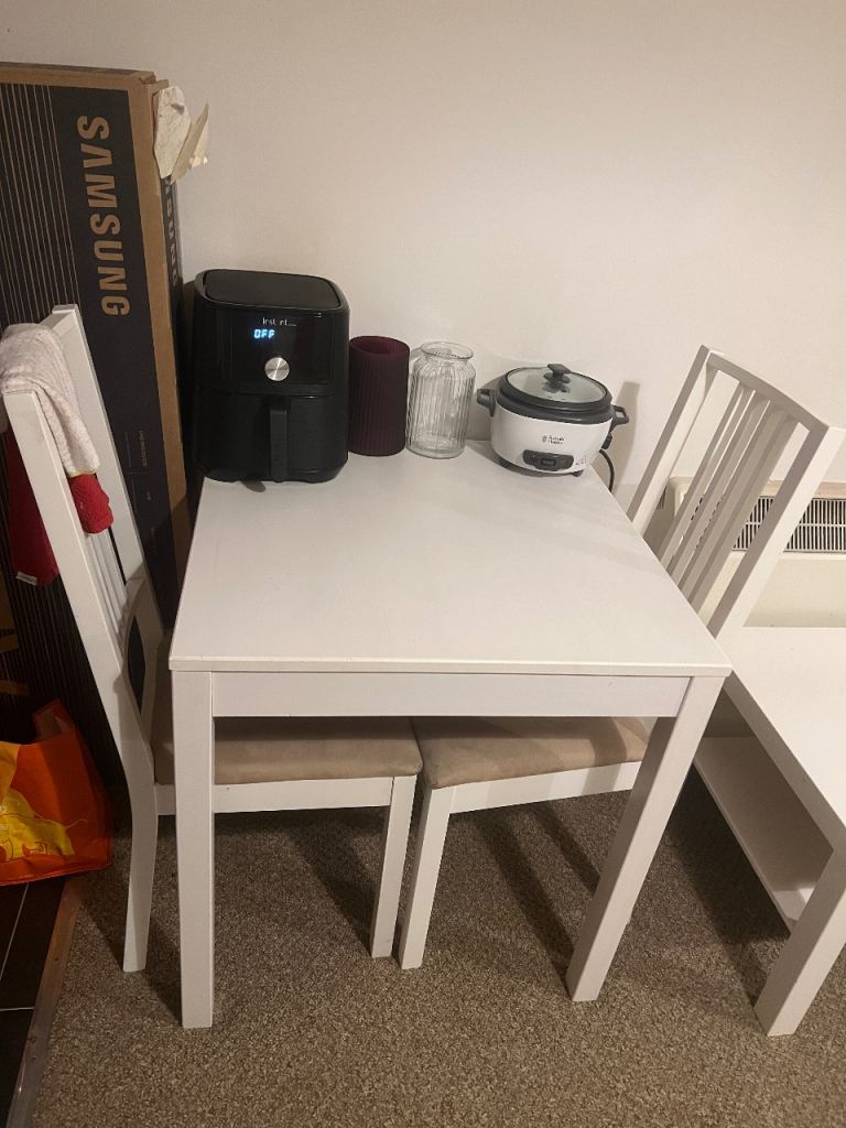 White square dining table and 2 chairs