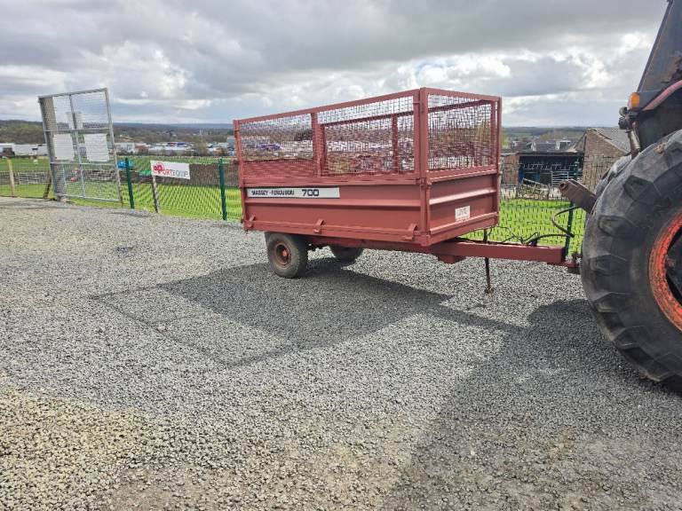 Compact tractor tipping trailer with mesh sides 