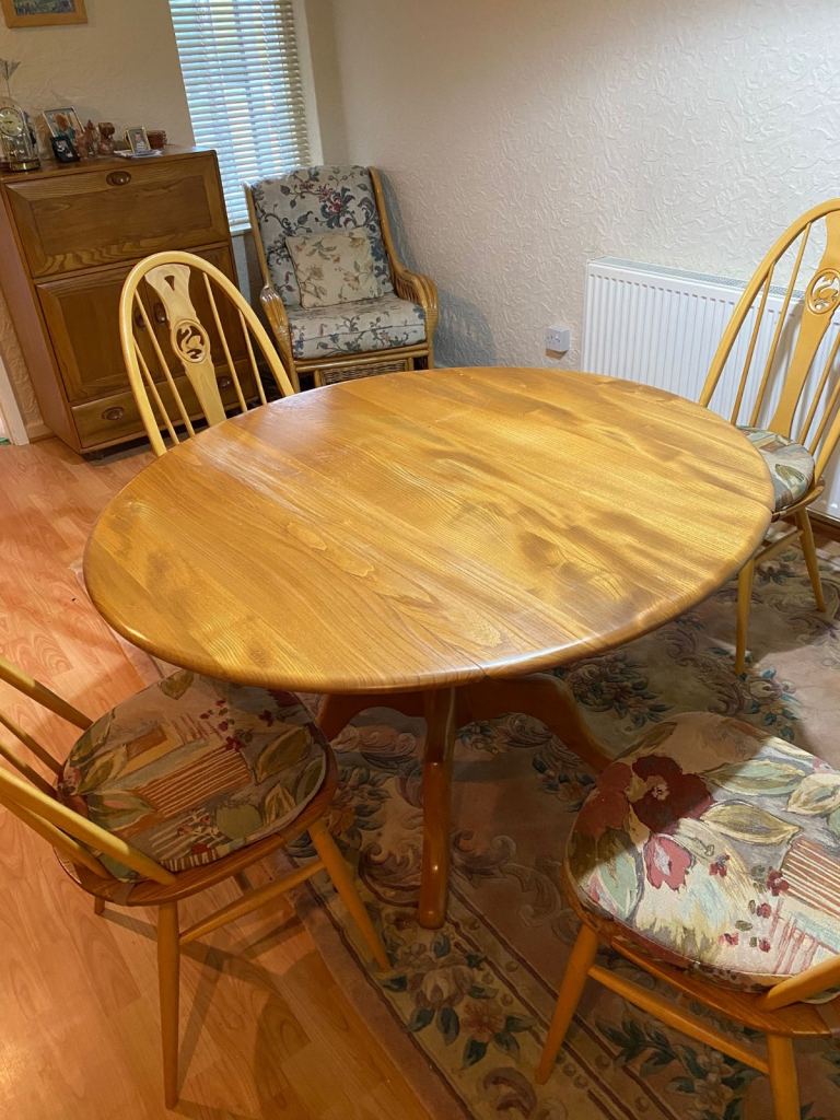 image for Ercol circular dining table with four chairs and Ercol cushions