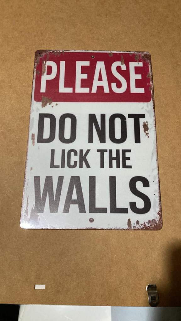 Belting tin wall sign