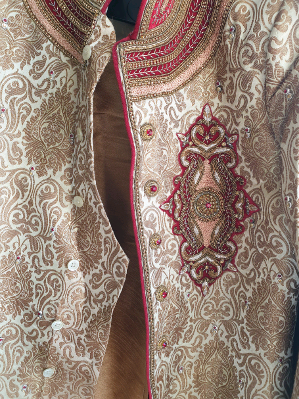Beautifully designed Gold and Burgundy Grooms Sherwani