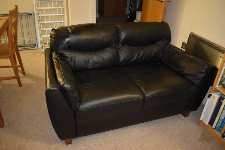 Black Leather Two-Seater Sofa – Reasonable Condition