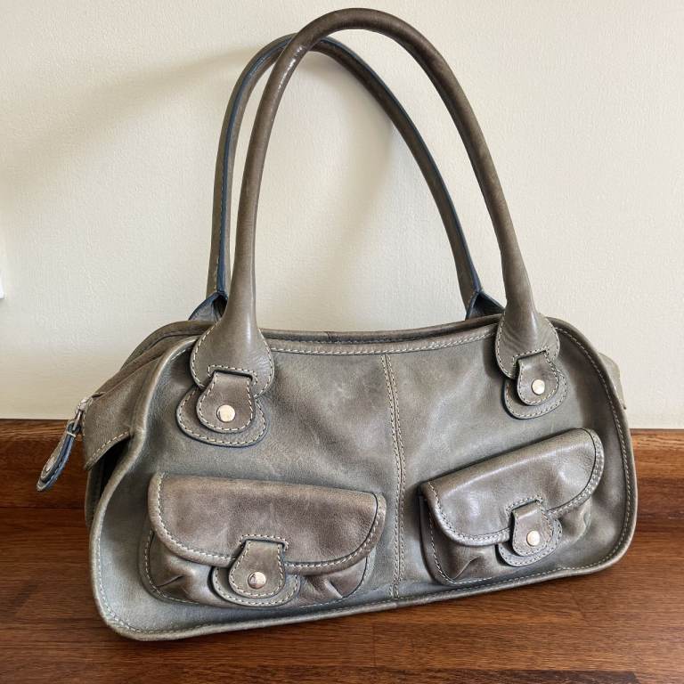 R12K light blue leather handbag. Leather in need of a clean. £7 ovno. Can post.