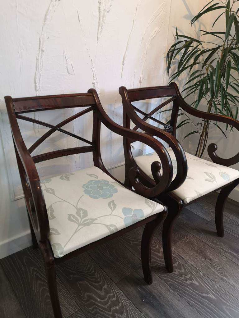 Two Brown Wooden Dining Chairs with Floral Cushions 