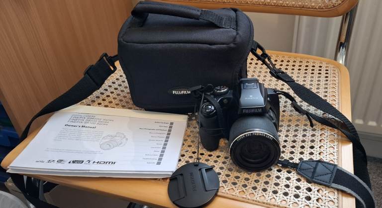 Fuji Film Finepix camera S9200 A good starter camera, a bridge camera so no extra lenses. 