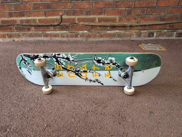 Skateboard with Cherry Blossom Design – Good Condition