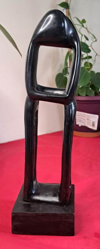 Thinking Man" or "Embracing Couple" sculpture. These pieces are often associated with African art