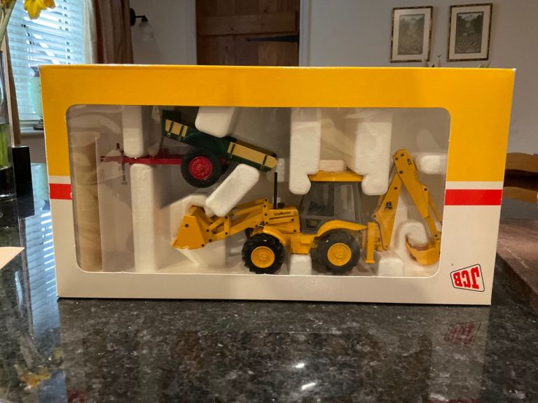 JCB 4CX Backhoe Loader and JBC Farm trailer metal models in presentation pack from 1995