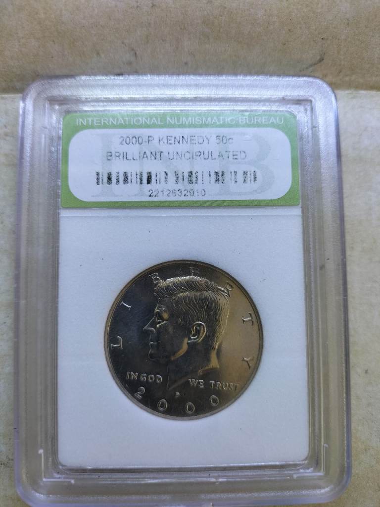 2000-P Kennedy 50-cent coin, officially graded as Brilliant Uncirculated encased in protective slab