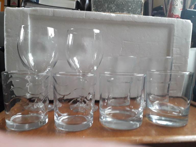 Two wine glasses, and 6 other glasses