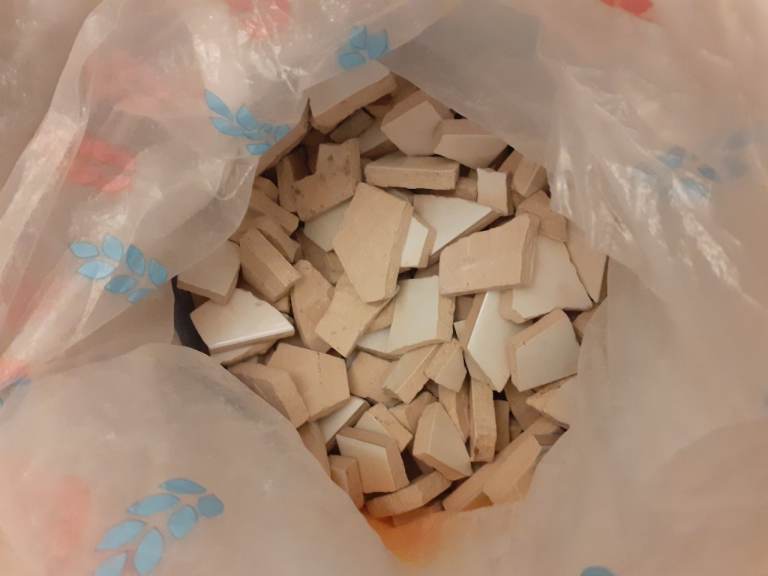 Bag of white broken tiles, perfect for mosaic art or other craft projects.