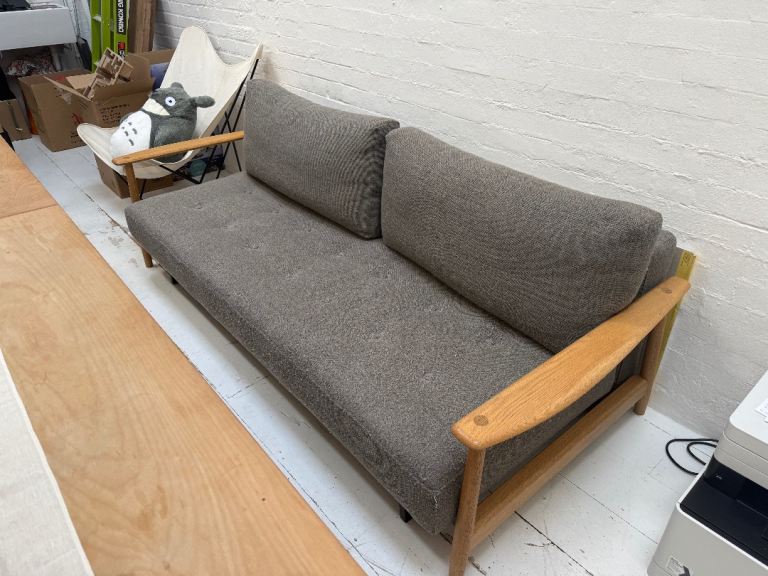 Stylish Grey Fabric Sofa Bed with Wooden Arms - Good Condition