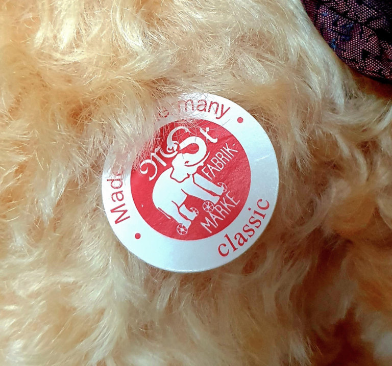 Steiff Bear with Bow and tag with gold plated button. Approx 12 inches