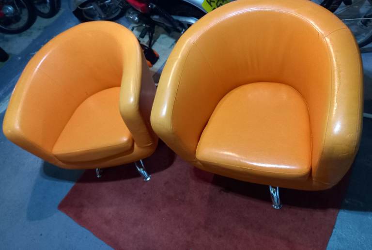 Pair of 1960s retro style orange swivel egg chairs with chrome base. 