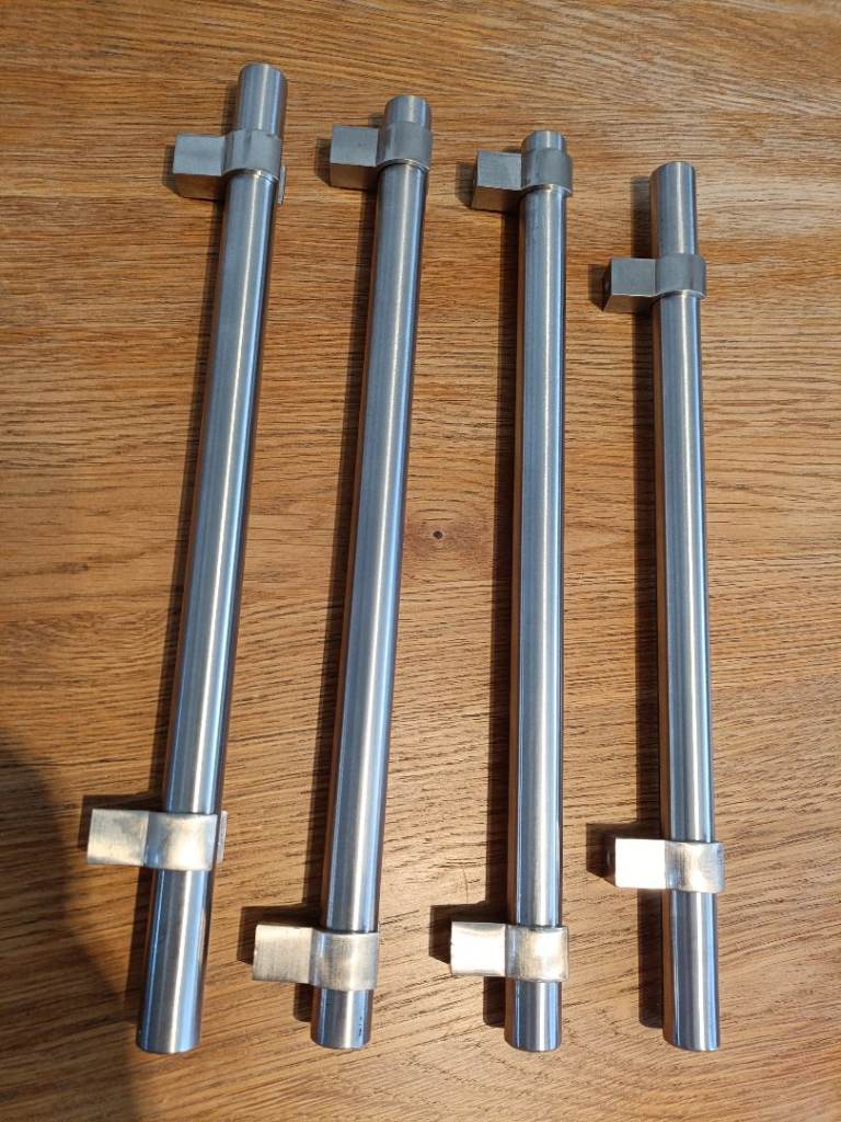 Stainless steel kitchen cupboard door handles.