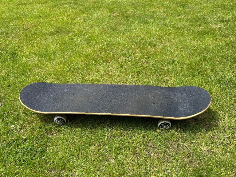 Skateboard with Black Grip Tape – Good Condition