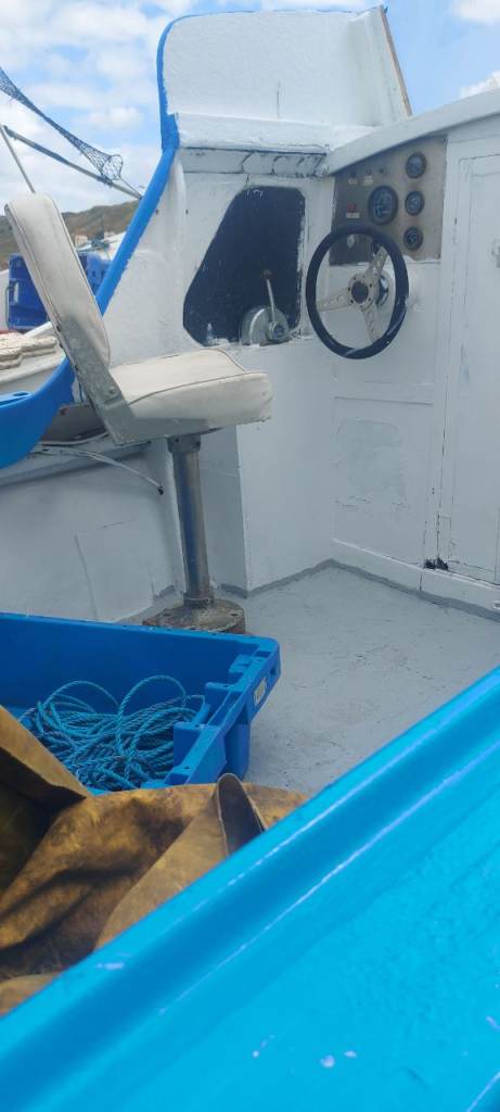 White Fishing Boat with Cabin and Steering Wheel