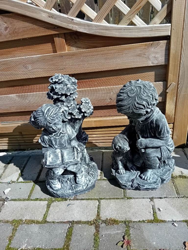 Concrete garden statues off boy with dog girl reading book £30 each or both for £50
