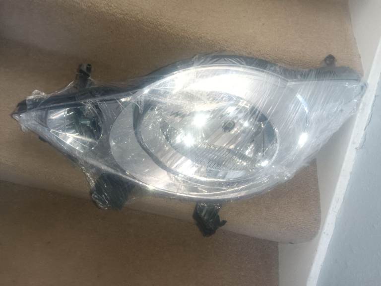 107 headlight passenger side new
