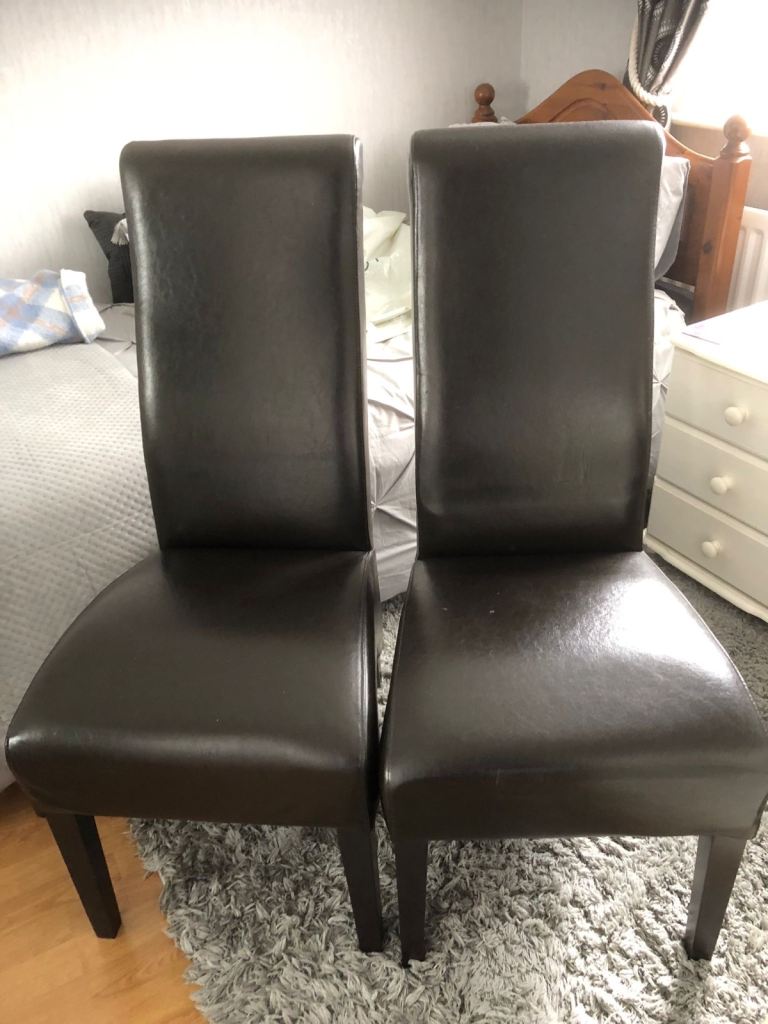 Two chocolate brown leather dining chairs for sale 