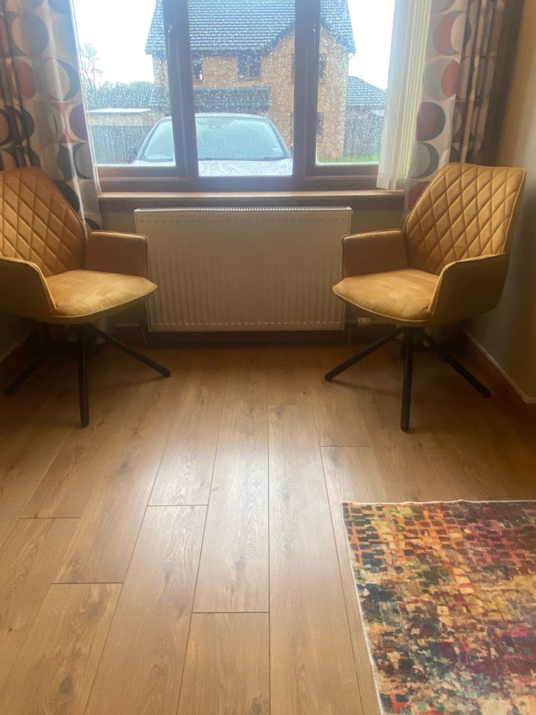 Two mustard chairs with swivel
