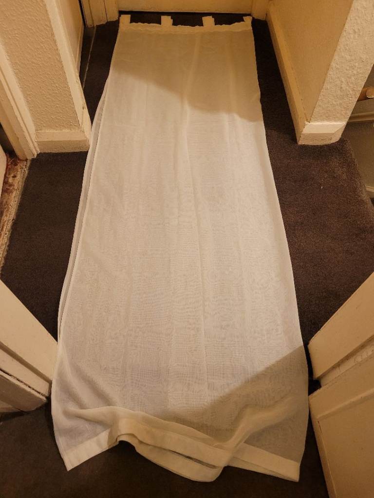 Off white tab top voile curtains with tie backs 