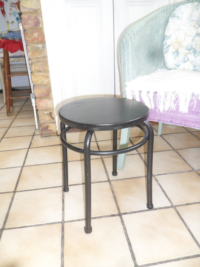 Small black round table 30cm diameter wood on metal legs. Multifunctional