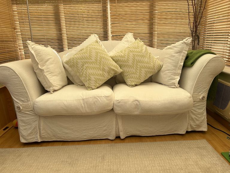 Comfortable Cream sofa with four cushions and spare cover set in yellow