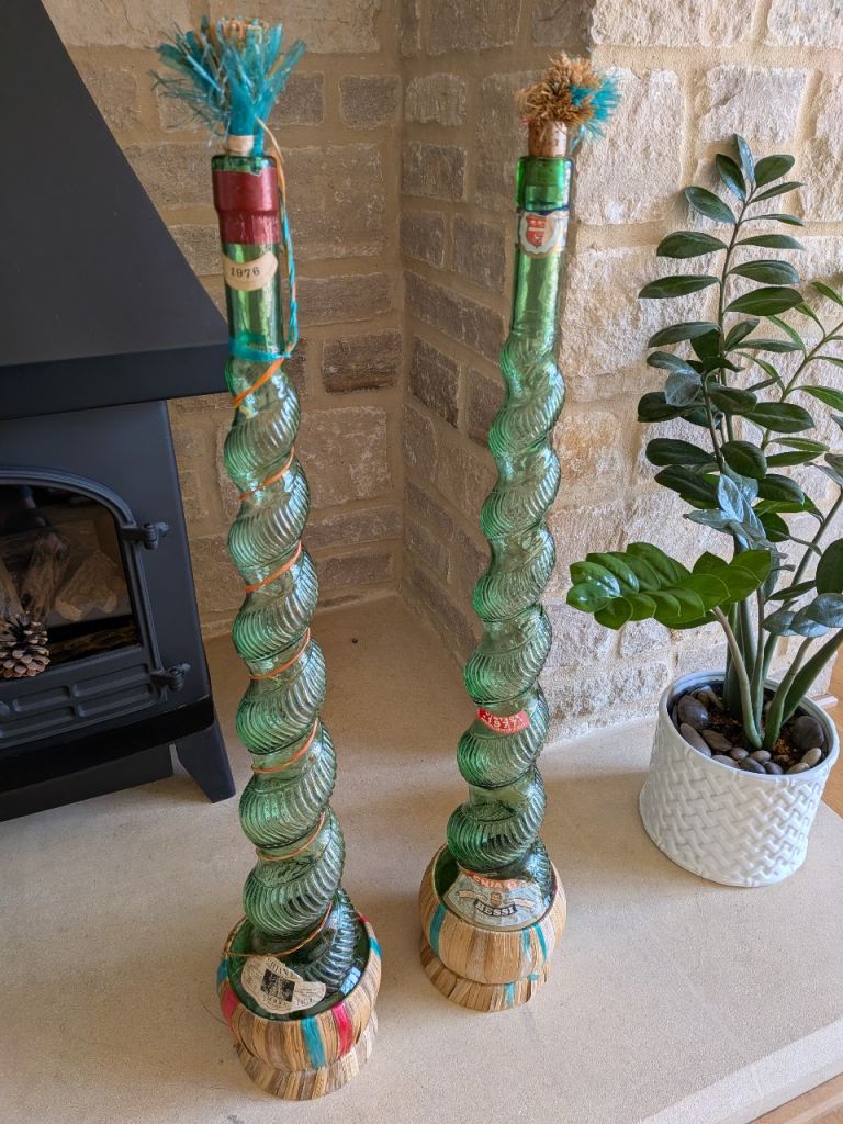 Two Tall Vintage Chianti Twisted Green Glass Bottles with Woven Rafia Bases Collect from BS9 or BS30