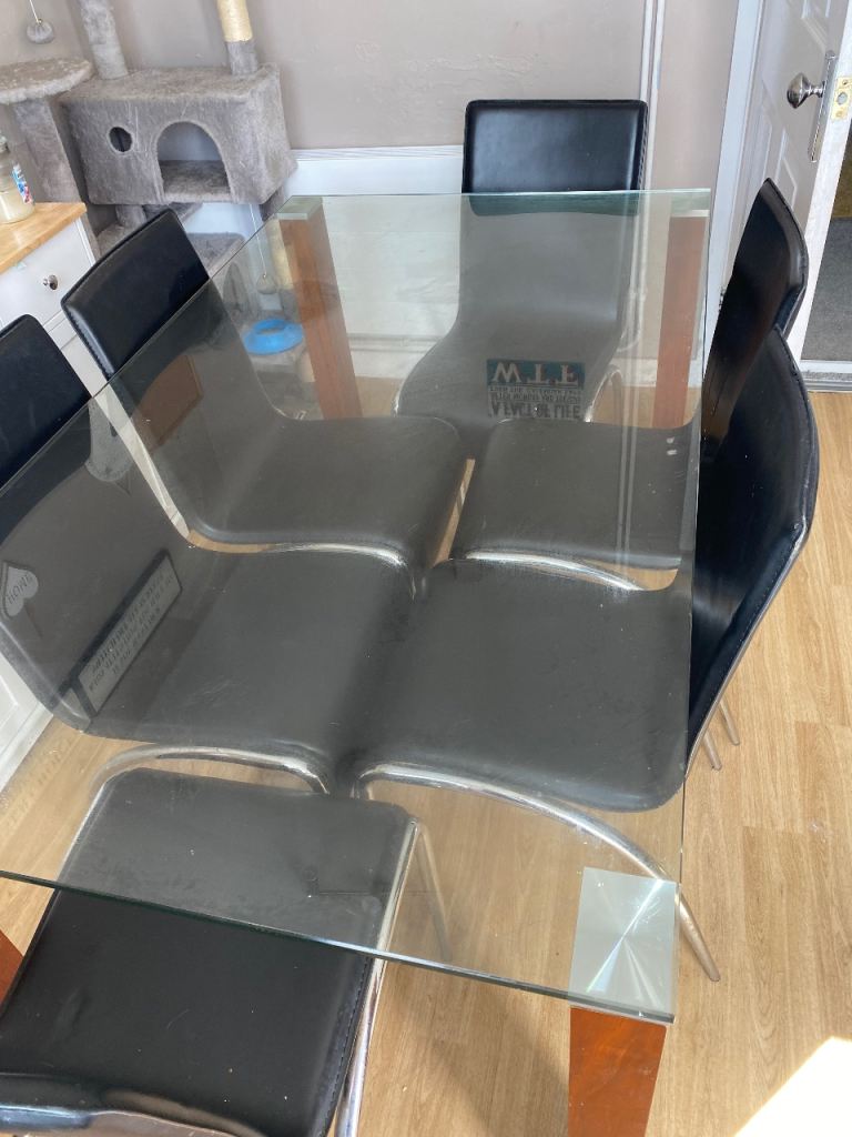 Glass Dining Table and Four Black Chairs – Good Condition