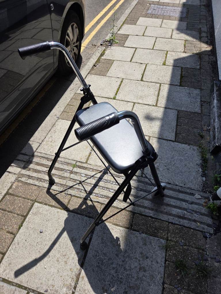 Walking aide with wheels and seat