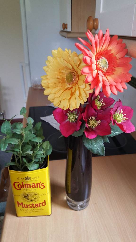 2 gorgeous artificial faux flowers in ornate vase and large mustard tin