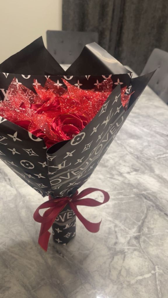 Red roses with diamonds on it wrapped in paper