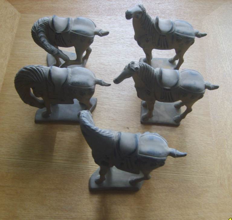 Five small ceramic Chinese ancient army style horses.