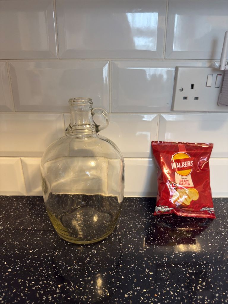 Vintage one-gallon clear glass demijohn, carboy, typically used for fermenting wine or beer. 10" 