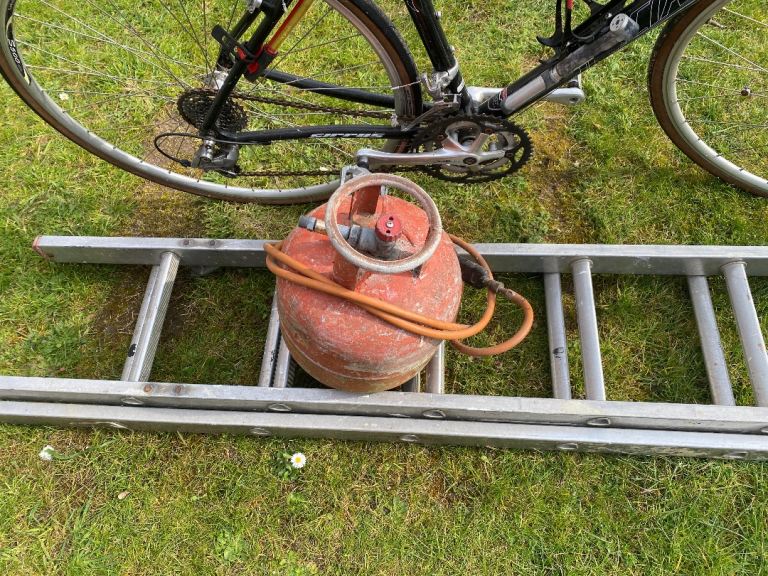 Empty gas bottle and torch