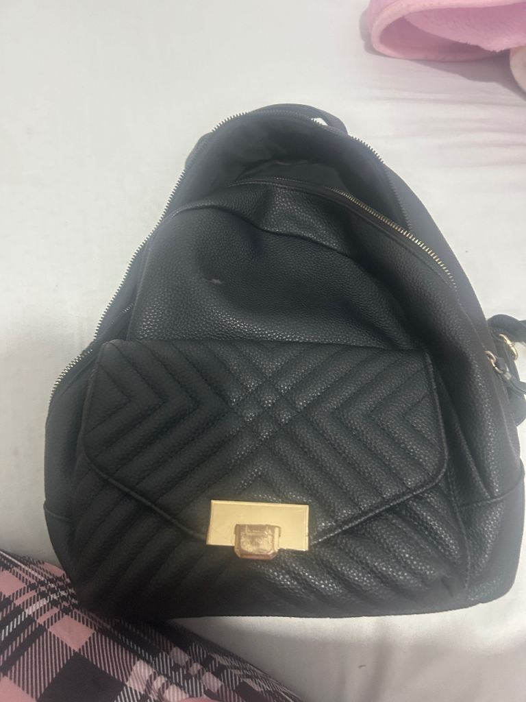 Black  Backpack with Gold Clasp – Good Condition