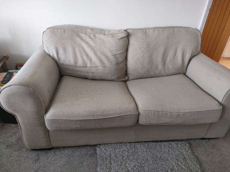 Clean beige coloured two seater sofa bed 