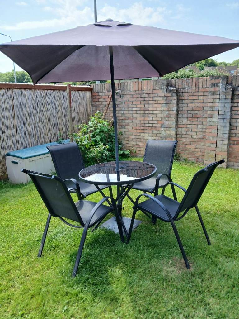 GARDEN PATIO FURNITURE - TABLE FOUR CHAIRS AND PARASOL WITH IRON BASE