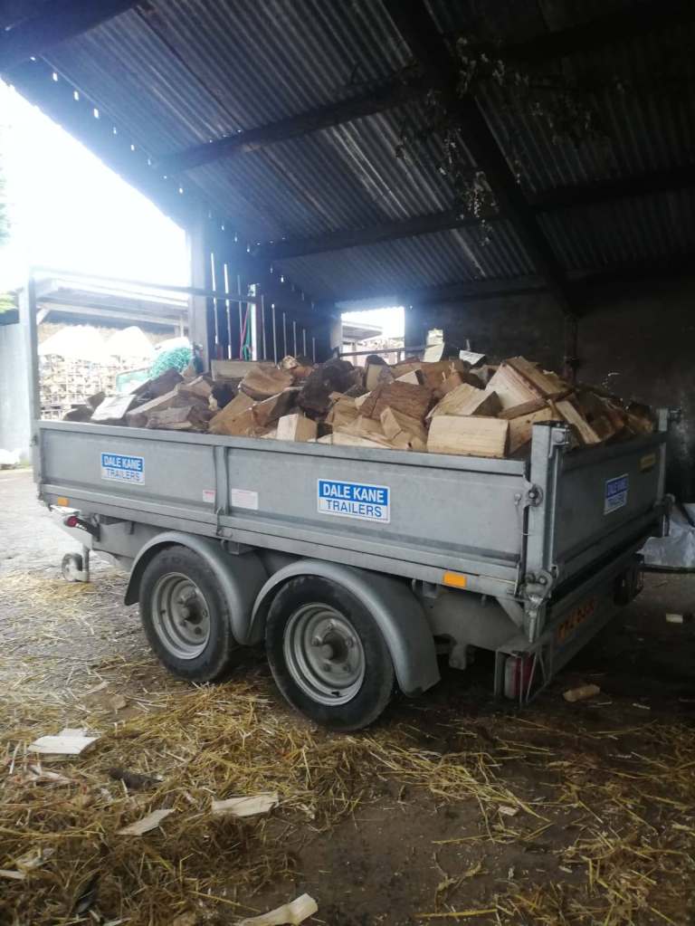 Trailer loads of seasoned firewood logs 