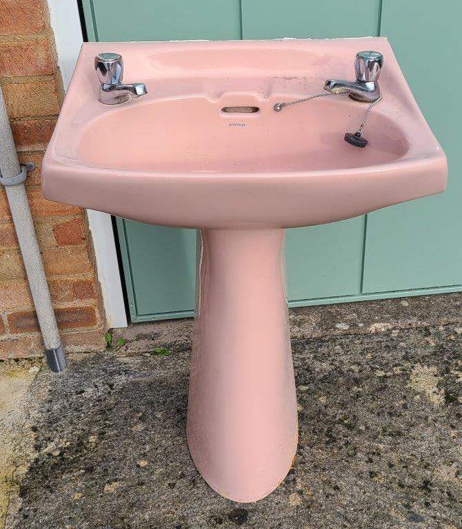 Retro pink bathroom sink and pedestal
