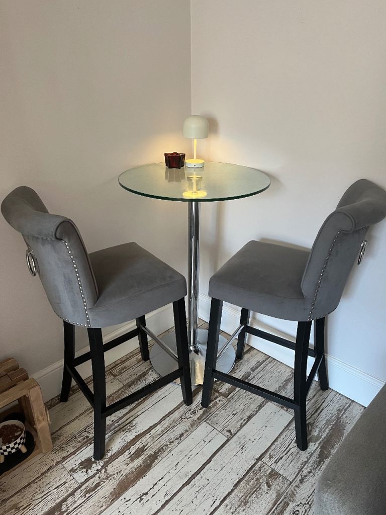 2grey velvet bar chairs and glass round table 