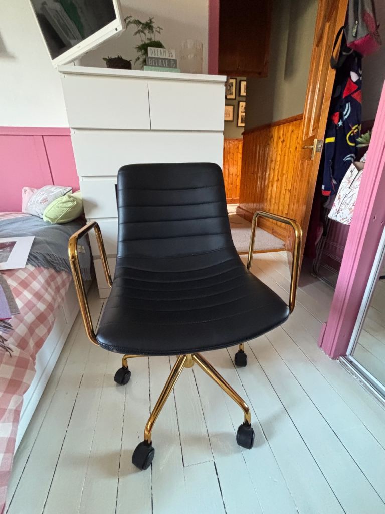 Black faux leather swivel seat. 