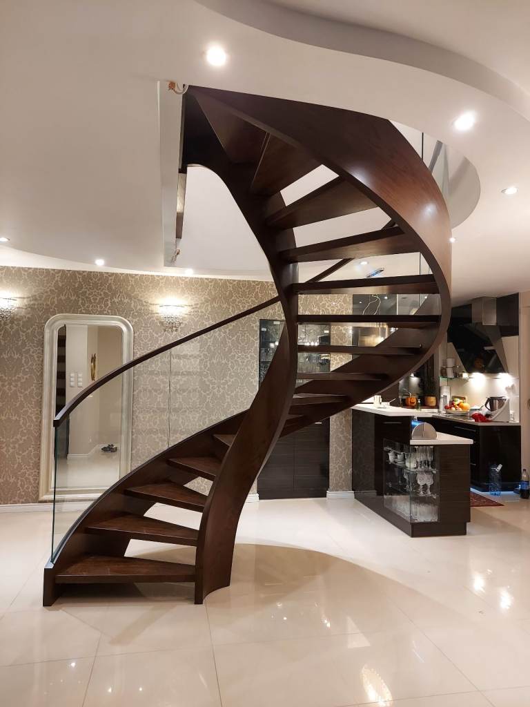 Curved luxury oak staircase with glass balustrade from Poland