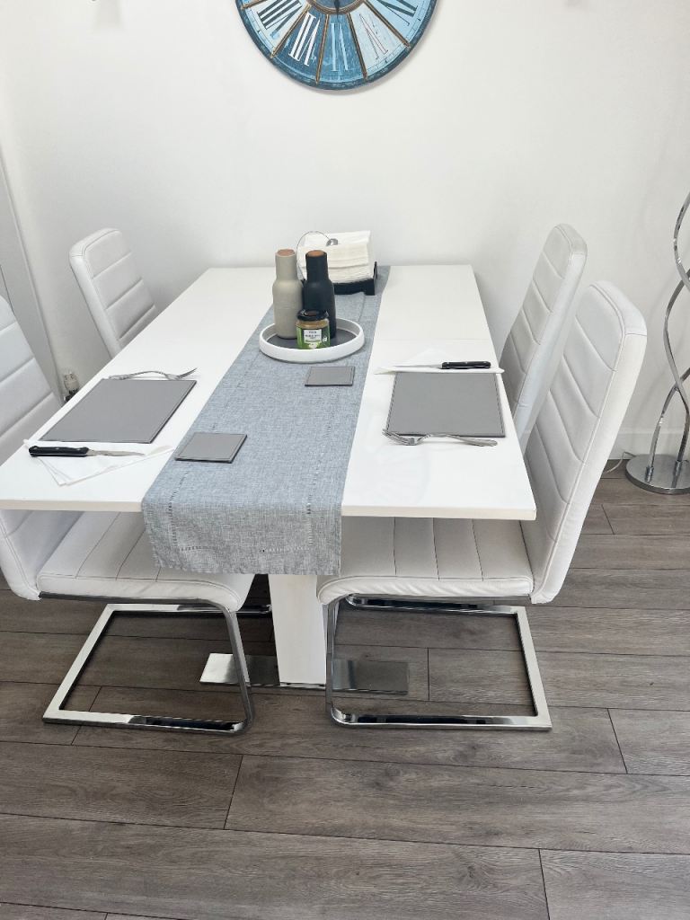 White Extending Dining Table with Four Faux Leather Chairs
