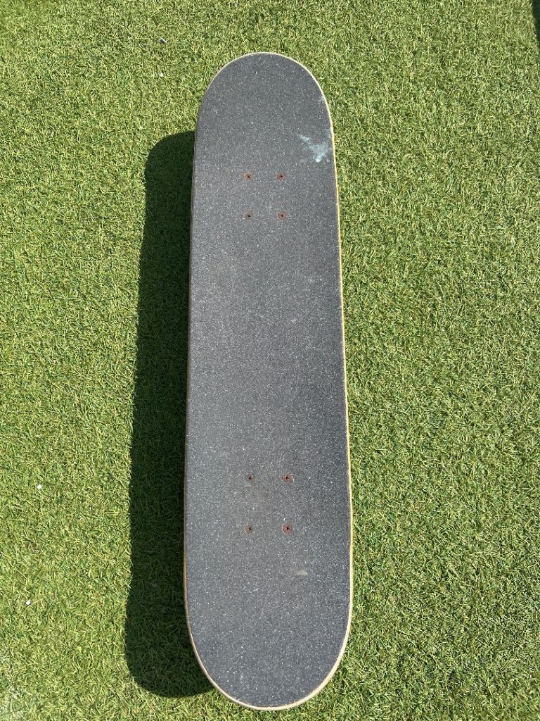 Skateboard with Black Grip Tape – Good Condition