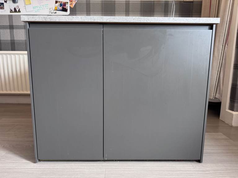 Kitchen units, work surface, central island and extractor fan.